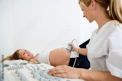 Technician Scanning Pregnant Woman's Belly