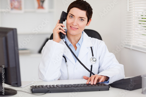 Wallpaper Mural Smiling female doctor making a phone call Torontodigital.ca