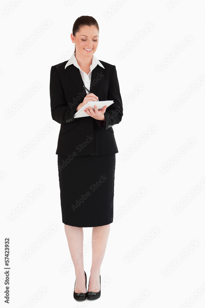Beautiful woman in suit writing on a notebook Beautiful woman in suit writing on a notebook
