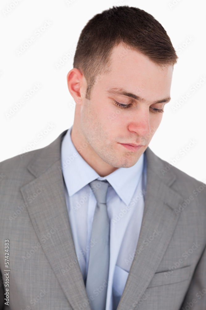Close up of serious businessman looking down Close up of serious businessman looking down