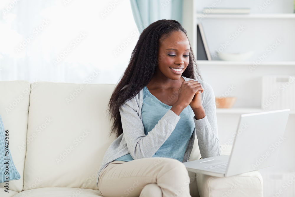 Woman on sofa looking at computer screen Woman on sofa looking at computer screen