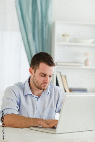 Businessman with rolled up sleeves working on his laptop