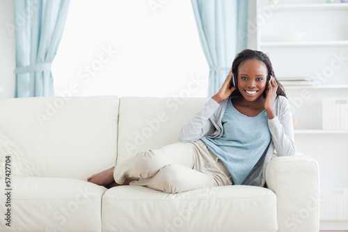 Woman relaxing in living room with music