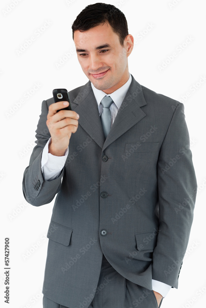 Smiling businessman looking at his cellphone Smiling businessman looking at his cellphone