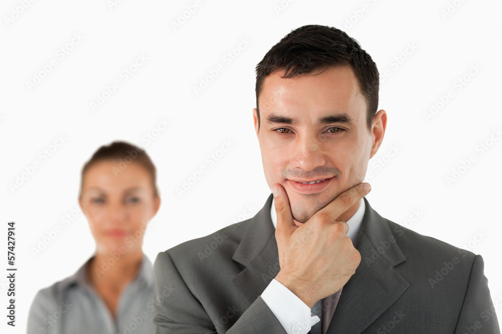 Close up of confident businessman with colleague behind him Close up of confident businessman with colleague behind him