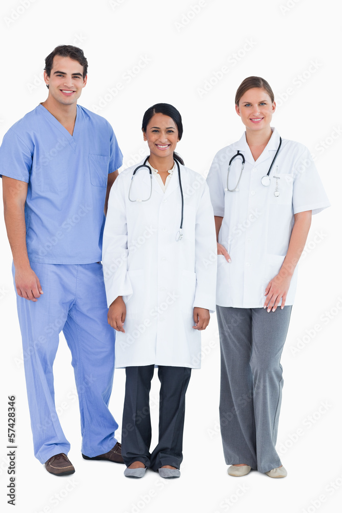 Smiling young medical staff standing together Smiling young medical staff standing together
