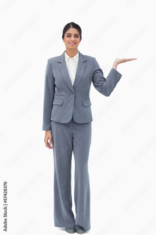 Smiling businesswoman presenting with palm up Smiling businesswoman presenting with palm up