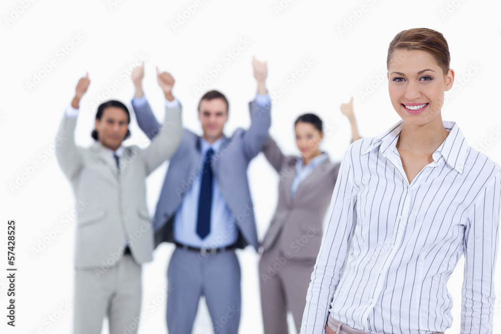 Close-up of a secretary smiling with enthusiastic business peopl Close-up of a secretary smiling with enthusiastic business peopl