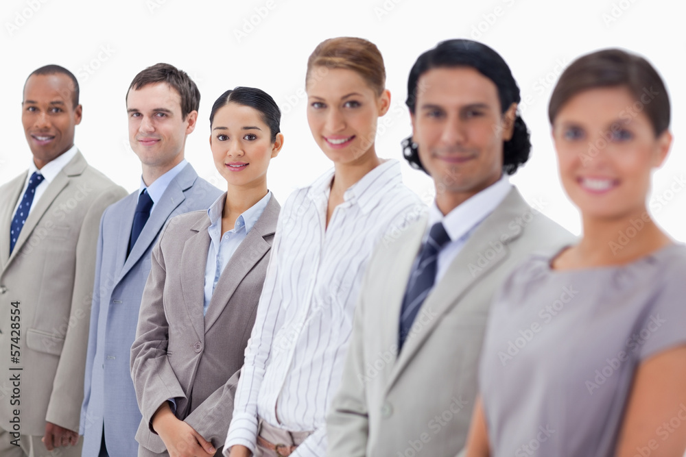 Close-up of smiling people dressed in suits looking straight