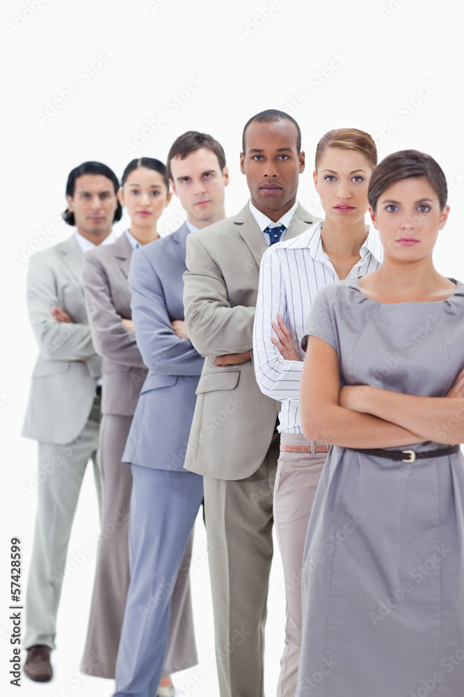 Close-up of a serious business team crossing their arms in a sin Close-up of a serious business team crossing their arms in a sin