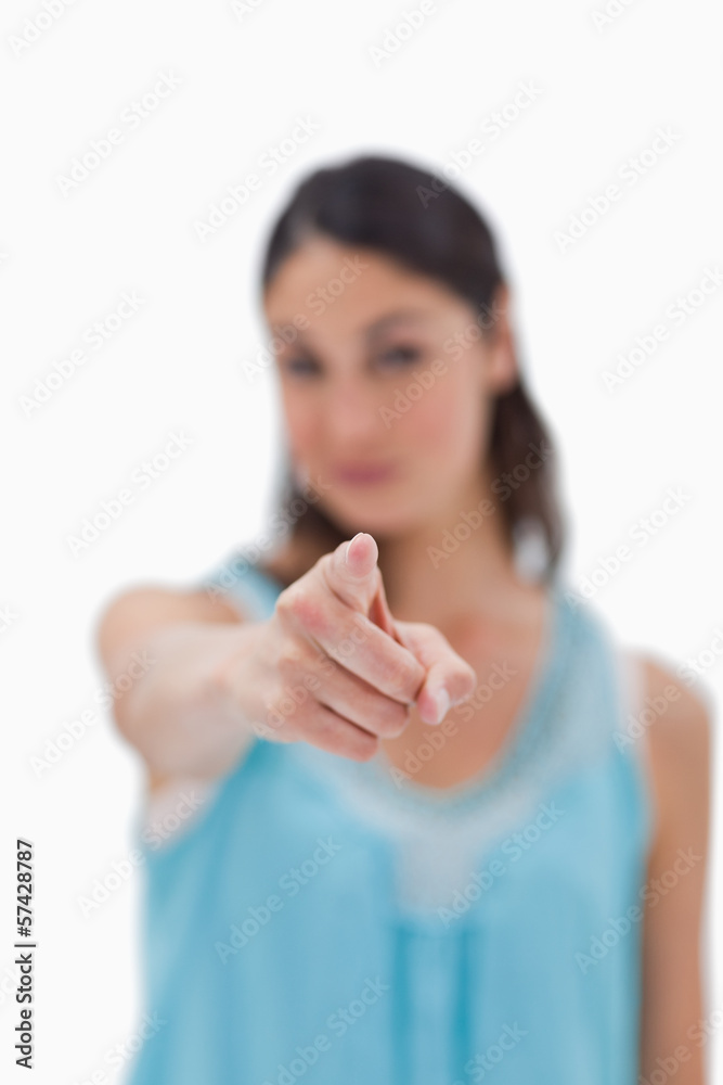 Portrait of a brunette woman pointing at the viewer Portrait of a brunette woman pointing at the viewer