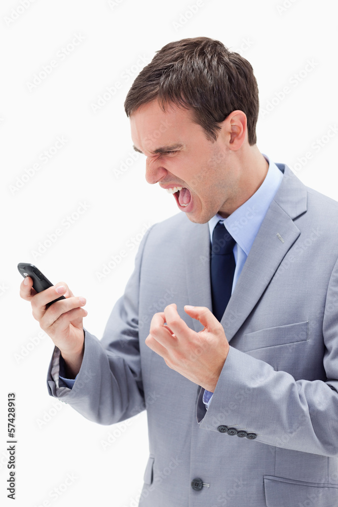 Angry businessman yelling at his cellphone Angry businessman yelling at his cellphone