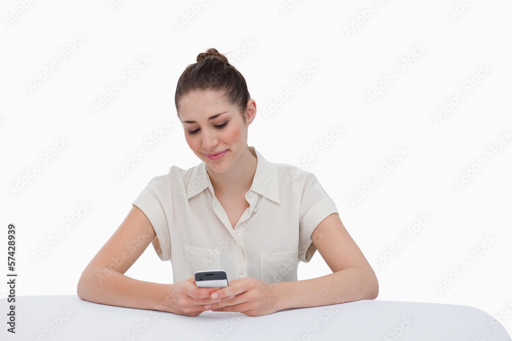 Young businesswoman writing a text message Young businesswoman writing a text message