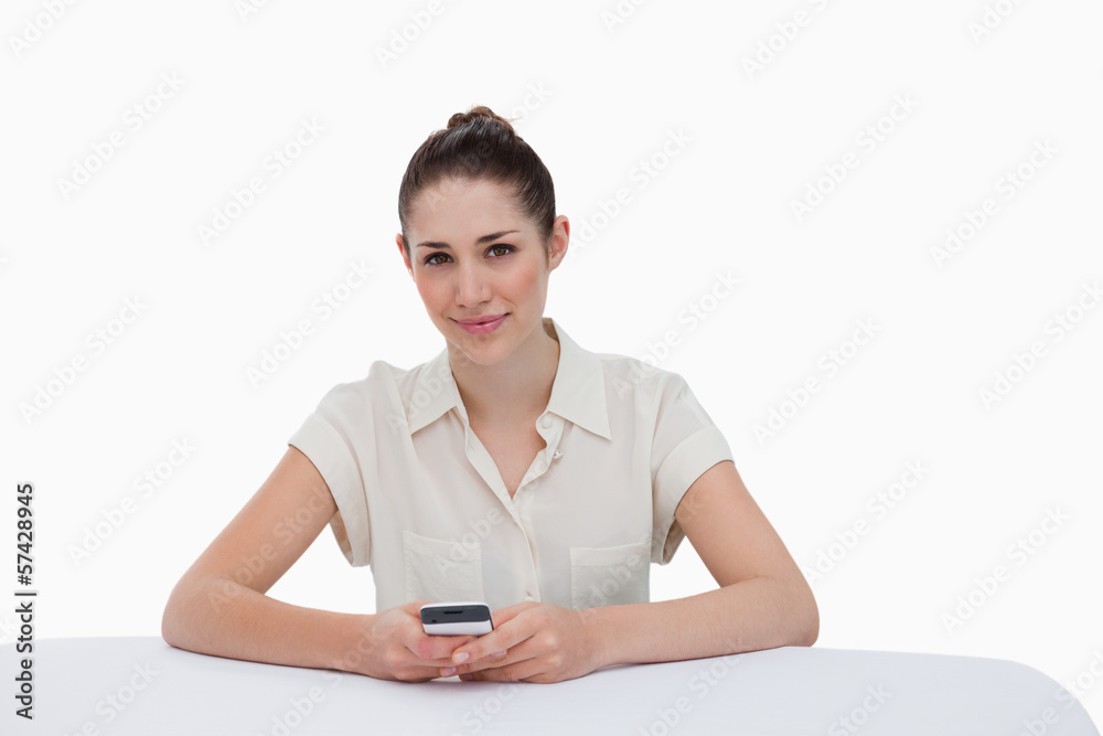Happy businesswoman writing a text message Happy businesswoman writing a text message