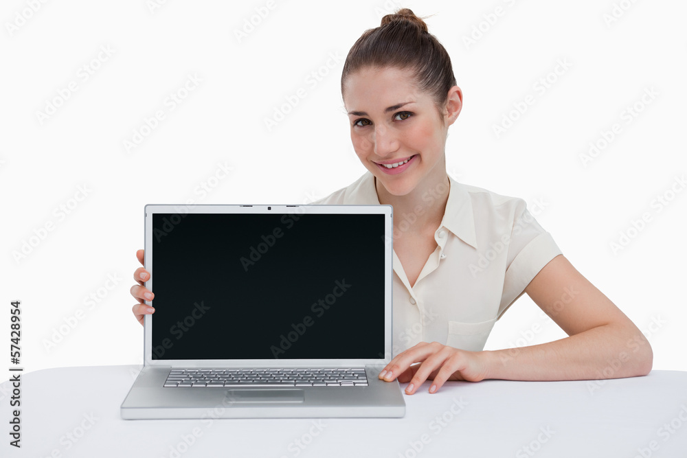 Smiling businesswoman showing a laptop Smiling businesswoman showing a laptop