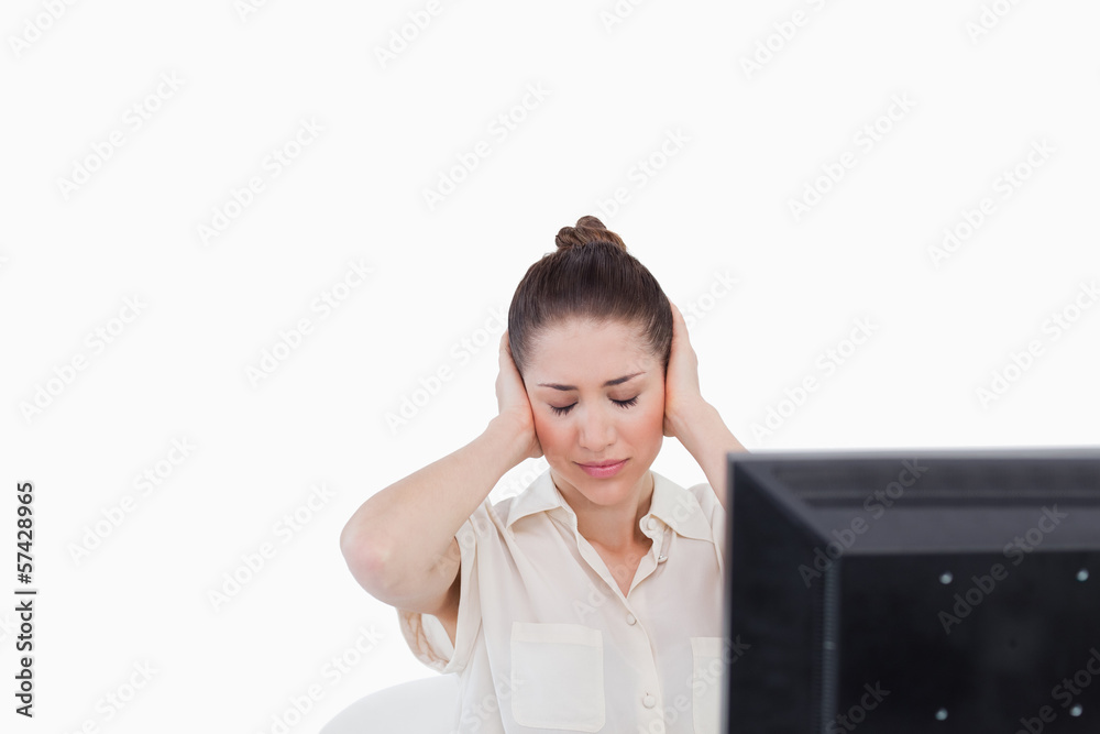 Businesswoman having a headache while using a computer Businesswoman having a headache while using a computer