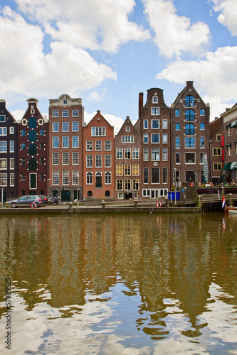 medieval houses over canal water in Amsterdam