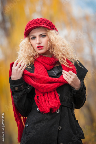 Attractive young woman with red cap in a autumn fashion shoot