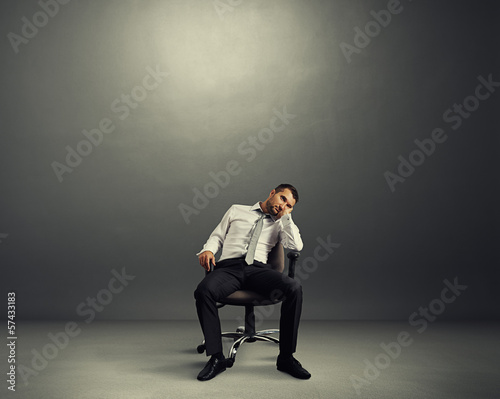 bored businessman sitting in the room photo