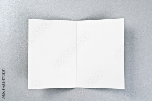 White open card over silver background