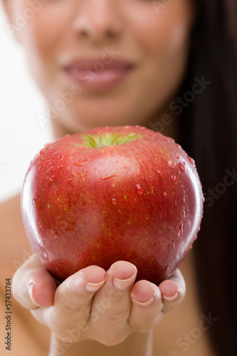  woman holding fresh red apple,selective focus on apple