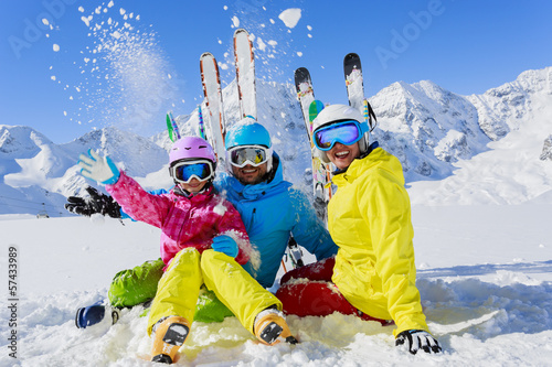 Skiing, skiers, sun and fun - family enjoying winter