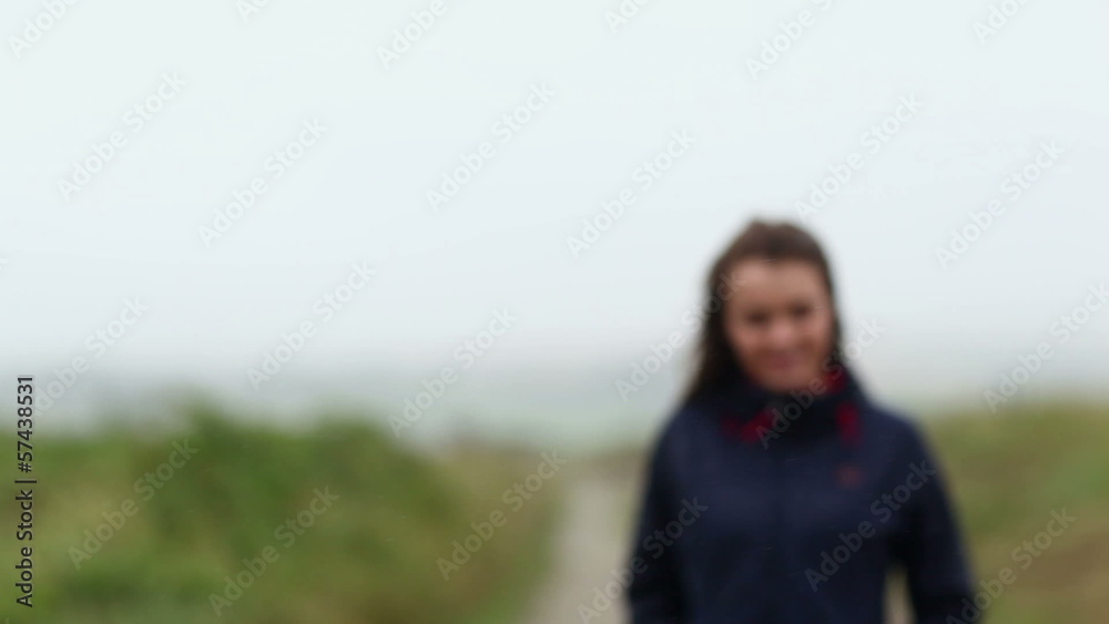 Content brunette walking on pathway towards camera Content brunette walking on pathway towards camera