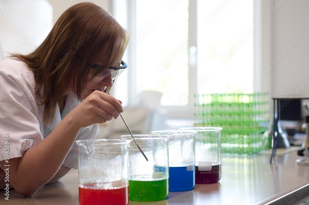 Female student experimenting in a lab Female student experimenting in a lab