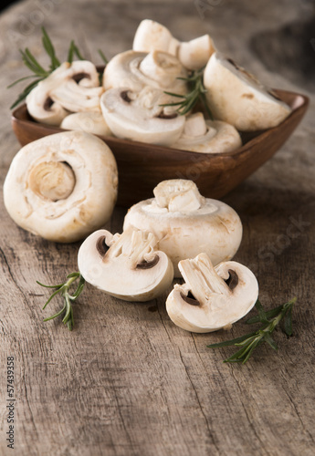 Fresh champignon mushrooms on wood