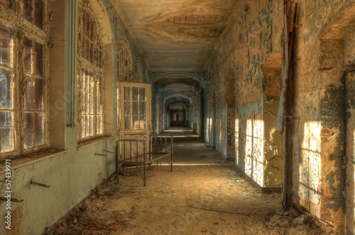 Abandoned hospital corridor with bed