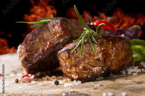 Grilled steaks on wood