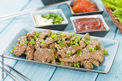 Bulgogi - Korean grilled beef with side dishes and lettuce