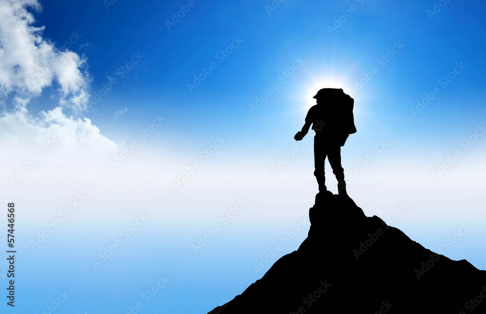 Silhouette of a winner on the mountain top