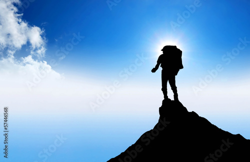 Silhouette of a winner on the mountain top