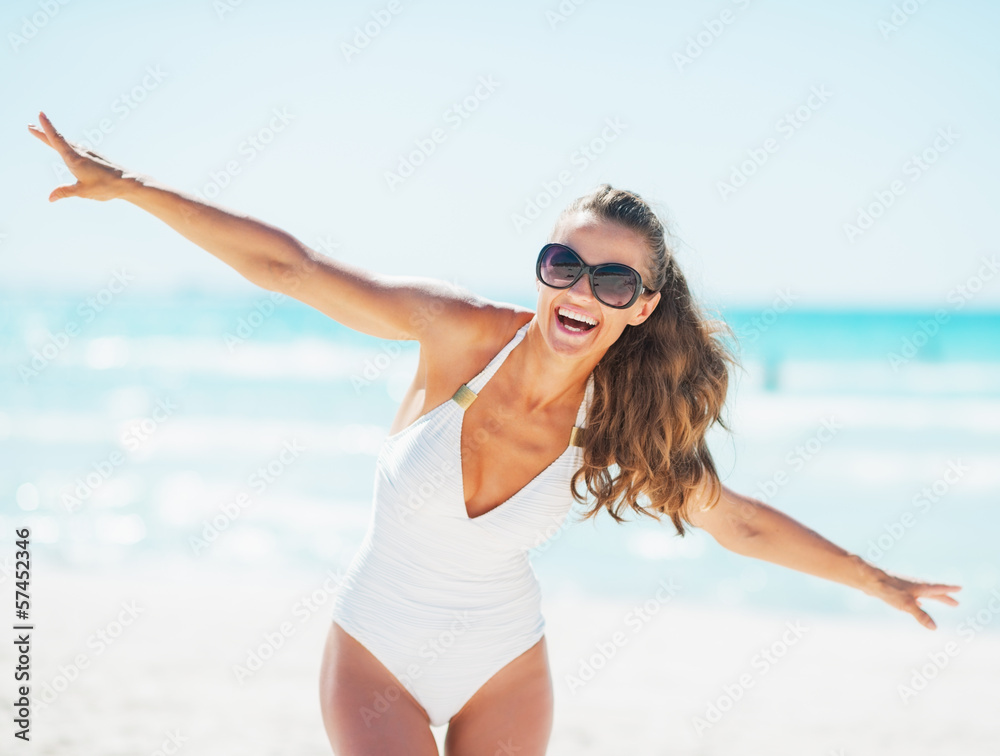 Happy young woman in swimsuit having fun time on beach Happy young woman in swimsuit having fun time on beach