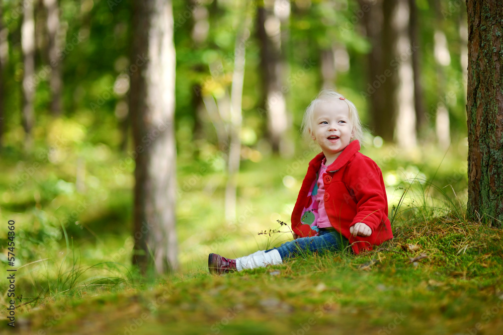 Adorable girl hiking in the forest on autumn day Adorable girl hiking in the forest on autumn day