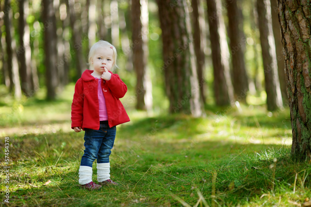 Adorable girl hiking in the forest on autumn day Adorable girl hiking in the forest on autumn day