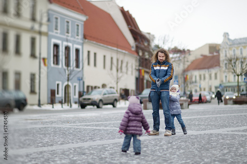 Young father and his girls on winter day © MNStudio