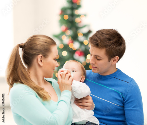 family and adorable baby with feeding-bottle © Syda Productions