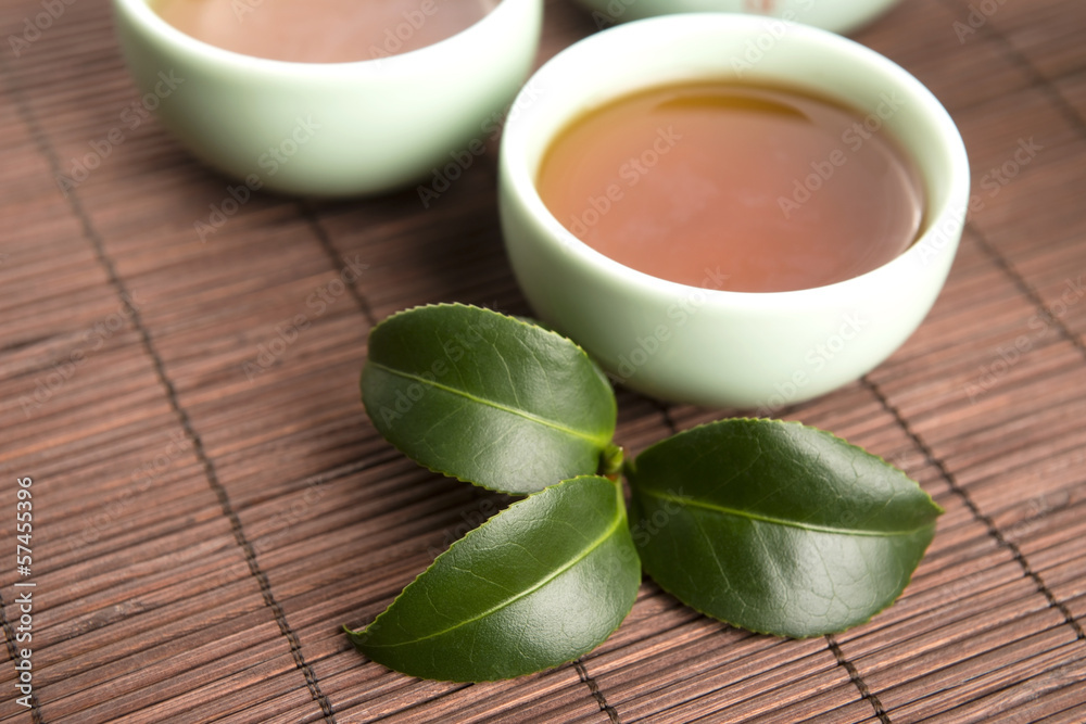 A cup of green tea with freh leaves A cup of green tea with freh leaves