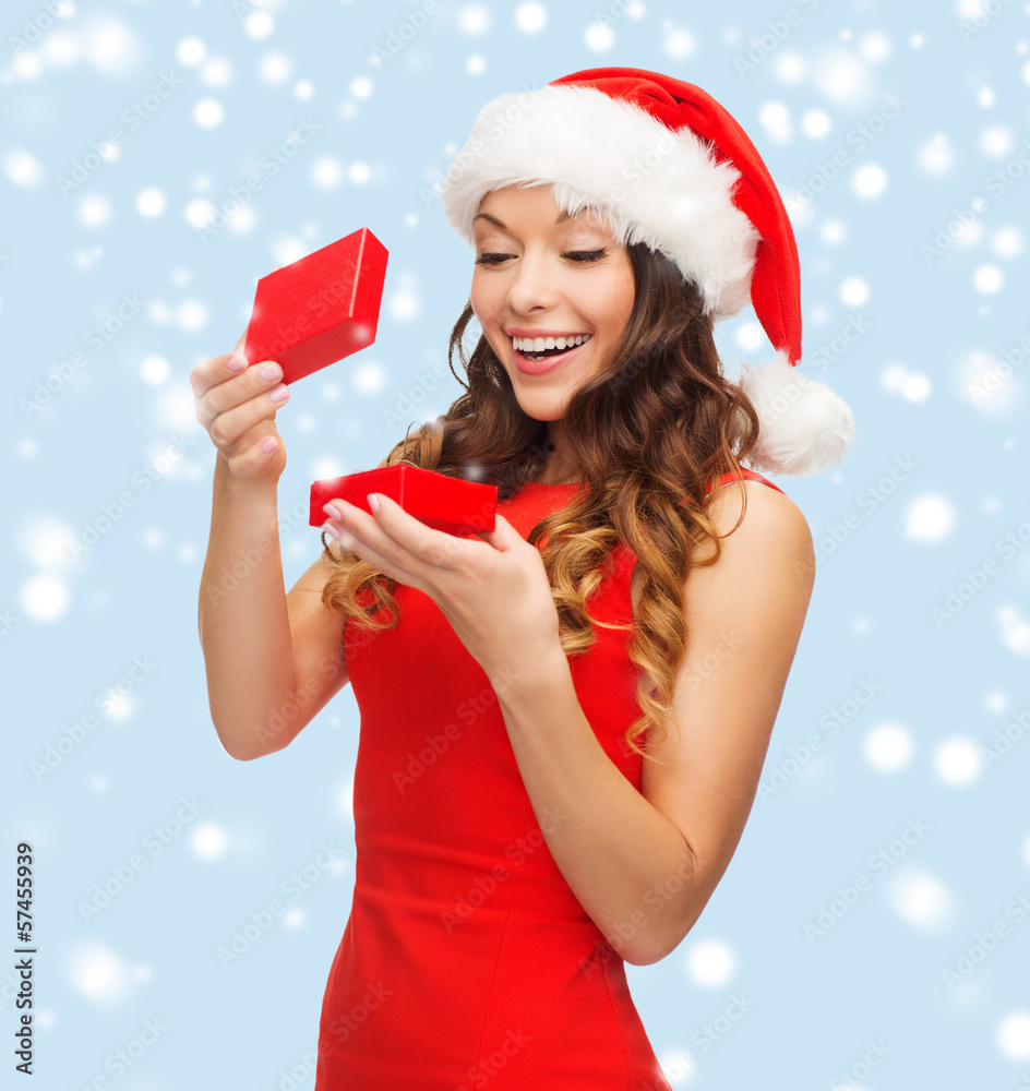 smiling woman in santa helper hat with gift box smiling woman in santa helper hat with gift box