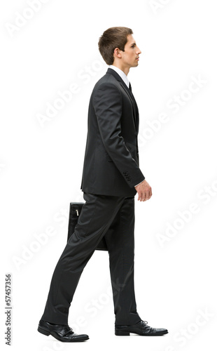 Full-length profile of walking with case businessman, isolated 