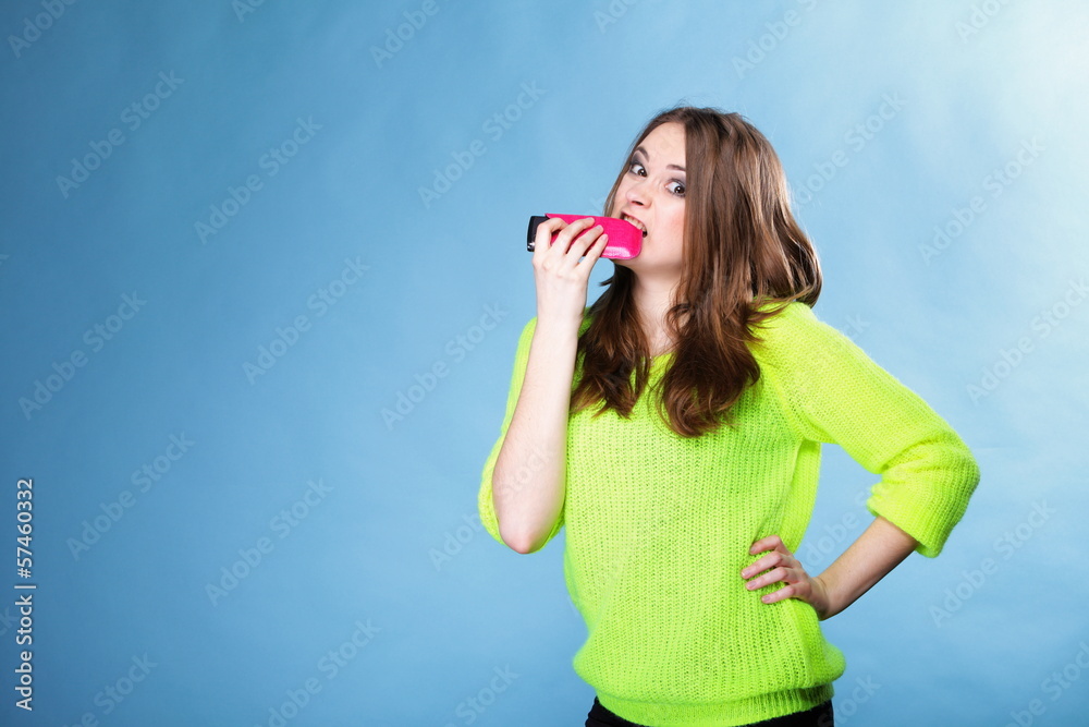 Happy girl with mobile phone in pink cover Happy girl with mobile phone in pink cover