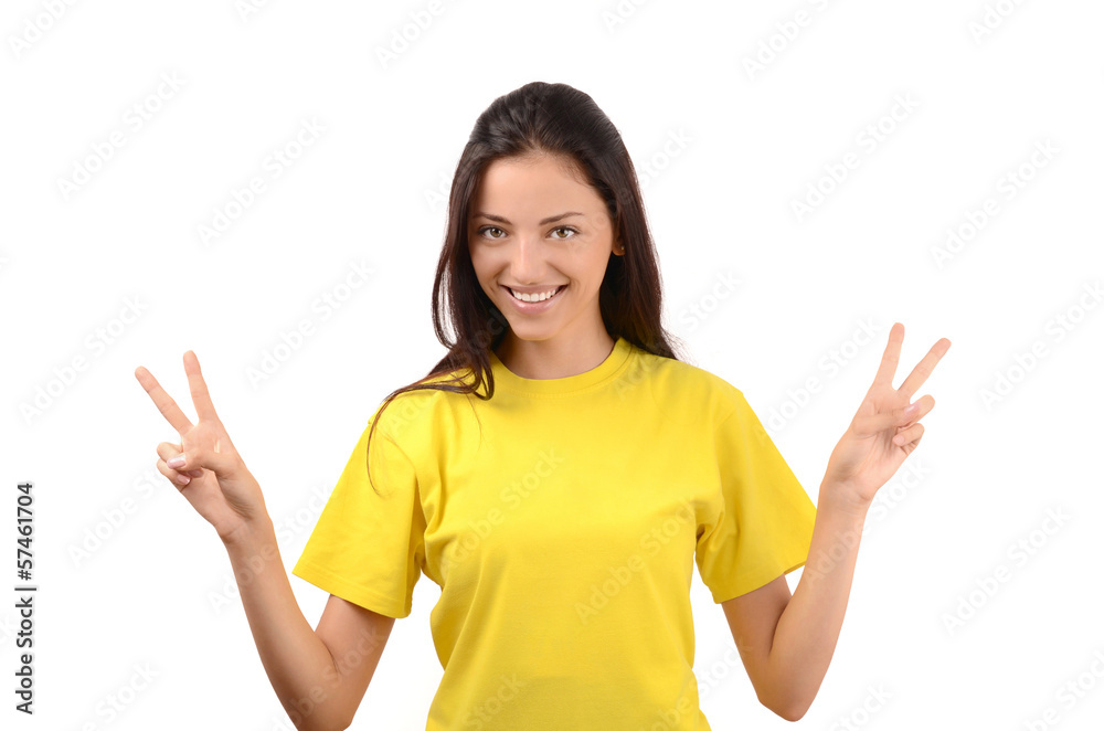 Happy girl with yellow t-shirt signing victory. Happy girl with yellow t-shirt signing victory.