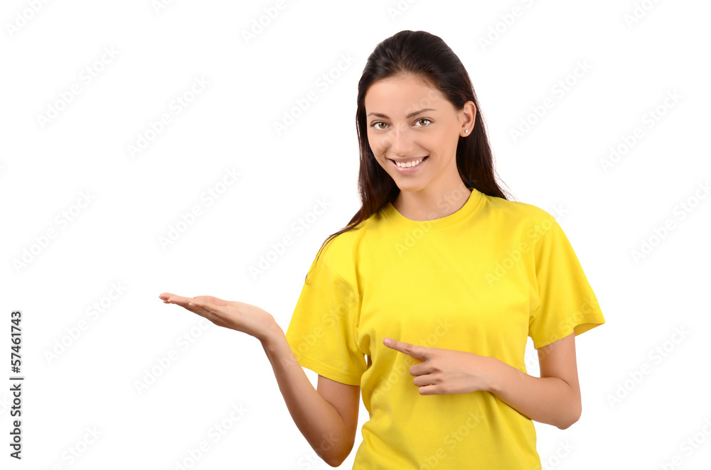 Beautiful girl with yellow t-shirt pointing and showing. Beautiful girl with yellow t-shirt pointing and showing.