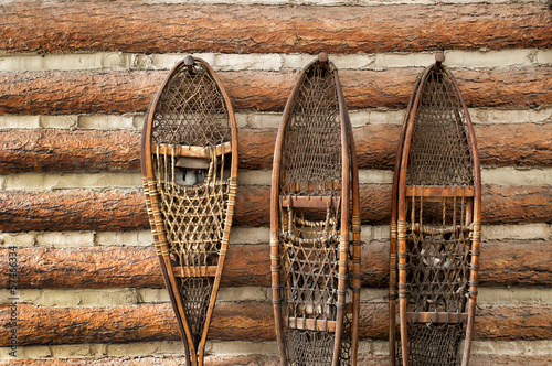 Snow shoes and a log cabin