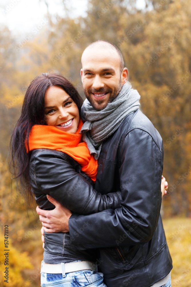 Fototapeta premium Happy middle-aged couple outdoors on beautiful autumn day