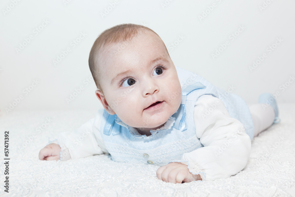 Cute baby lying on white blanket and smiling Cute baby lying on white blanket and smiling