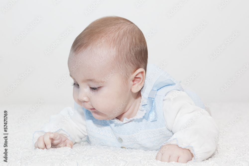Cute baby lying on white blanket and smiling Cute baby lying on white blanket and smiling