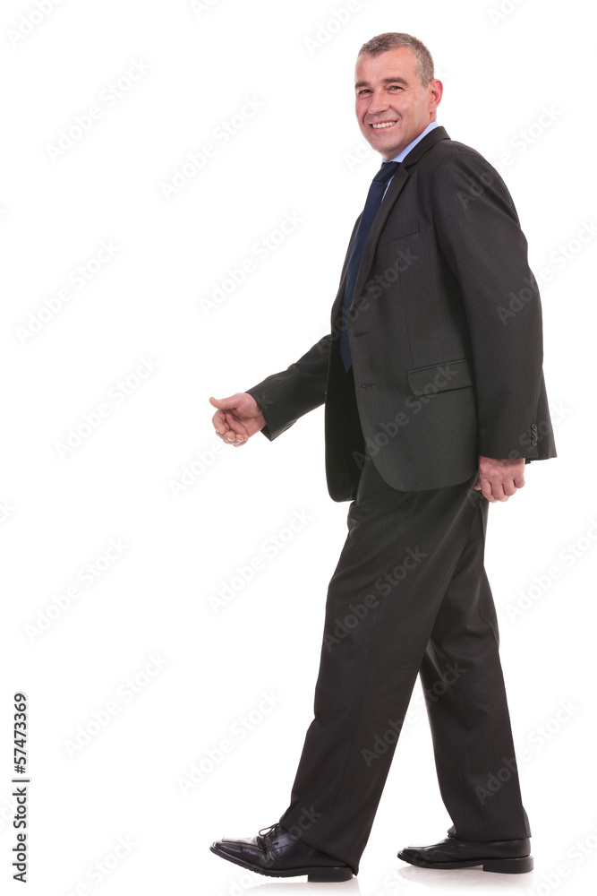 side of a business man walking and looks at you side of a business man walking and looks at you